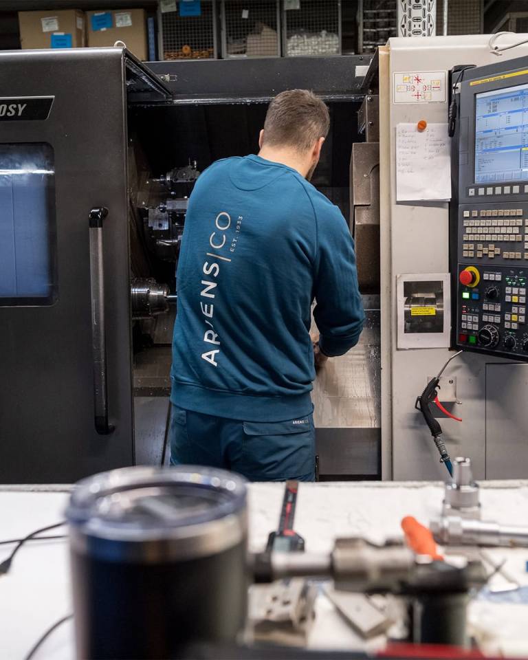 Factory worker of AriensCo EMEAA wearing their new turquise work wear inside their factory in Bühlertann, Germany