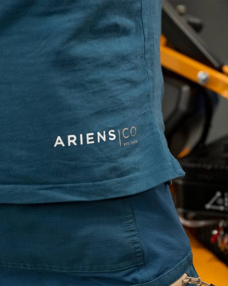 Factory worker of AriensCo EMEAA wearing their new turquise work wear inside their factory in Bühlertann, Germany