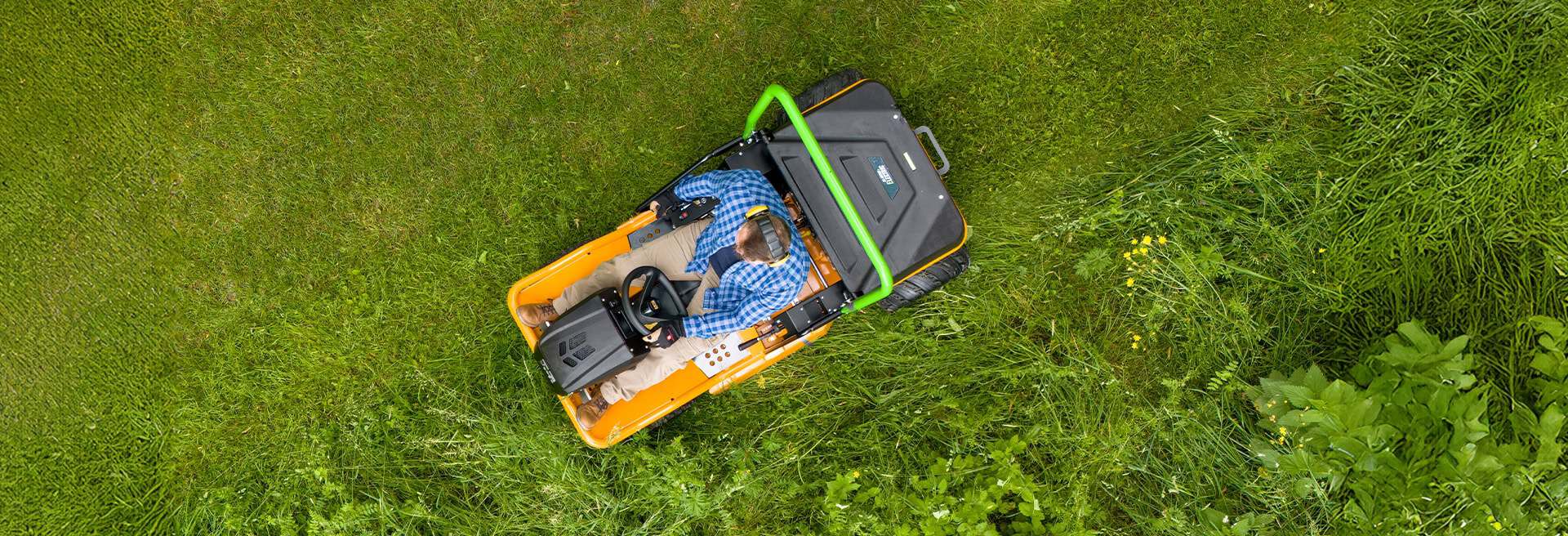 birdseye top-down-view shot of a AS-Motor AS 920 E-Sherpa 2WD mowing tall grass on a lawn